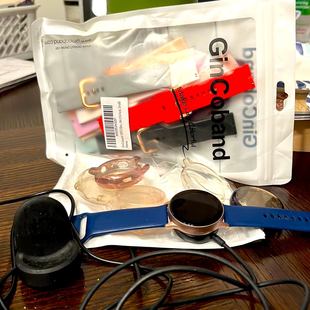 Samsung galaxy watch w/screen protectors and assorted bands/spare charger